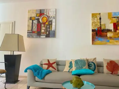 a living room with a couch and a table at Spacieux et confortable appartement T3 au centre ville d Ajaccio in Ajaccio