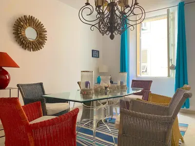 a dining room with a glass table and chairs at Spacieux et confortable appartement T3 au centre ville d Ajaccio in Ajaccio