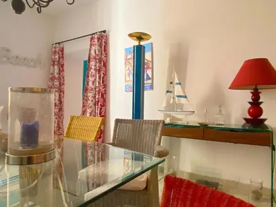 a dining room with a glass table and a desk at Spacieux et confortable appartement T3 au centre ville d Ajaccio in Ajaccio