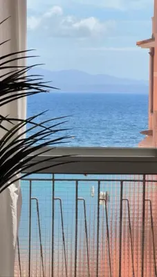 a living room with a couch and a table at L'Ajax Appartement T3 centre et Bord de mer in Ajaccio