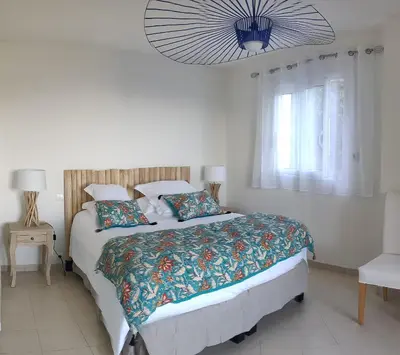 a bedroom with a large bed and a chandelier at Villa U Tramontu in Granace
