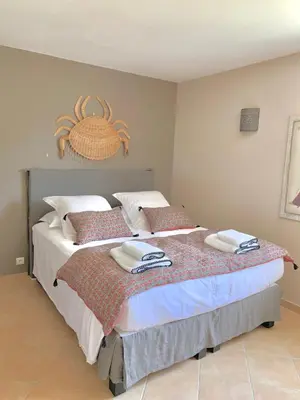 a bedroom with a large bed with towels on it at Villa U Tramontu in Granace