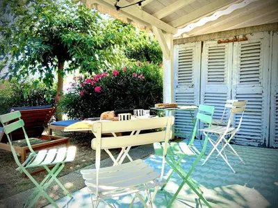 a patio with chairs and a table and a table and chairs at La Casetta Prunete in Cervione