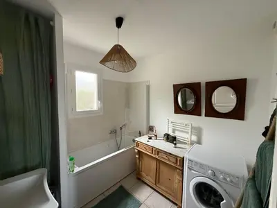 a bathroom with a sink and a washing machine at La Casetta Prunete in Cervione