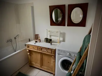 a bathroom with a washing machine and a washer at La Casetta Prunete in Cervione