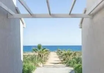 a view of a beach through a window at La Casetta Prunete in Cervione