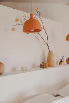 a shelf with a lamp and a plant on it at VILLA FLAKA Boutique Hôtel Wellness in Cargèse