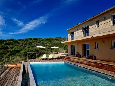 a villa with a swimming pool and a house at Modern villa 5 double bedrooms, new AC, private pool and stunning view 800 m from beach in Sagone