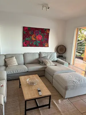 a living room with a couch and a coffee table at Modern villa 5 double bedrooms, new AC, private pool and stunning view 800 m from beach in Sagone
