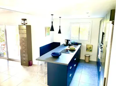 a kitchen with a blue island in a room at Villa Jeannette in Grosseto-Prugna