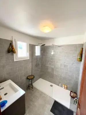 a bathroom with a white tub and a sink at Villa Jeannette in Grosseto-Prugna