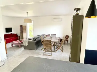 a living room with a couch and a table and chairs at Villa Jeannette in Grosseto-Prugna