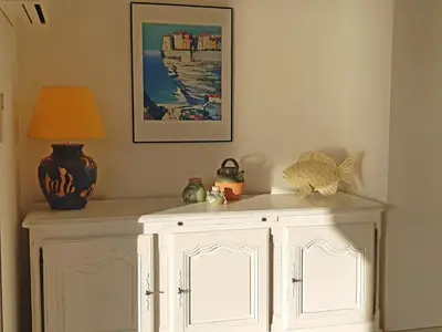 a white cabinet with a lamp on top of it at Les Terrasses du Pano - 95 m2 au calme - Jardin - Barbecue - Transats - Pleine vue mer - Wifi Fibre in Porticcio