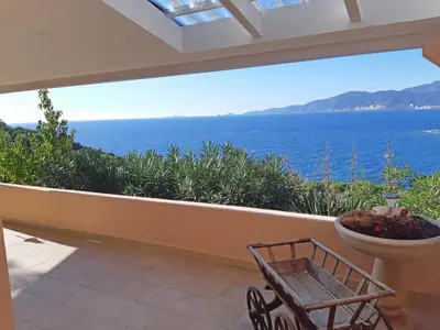 a view of the ocean from a house balcony at Les Terrasses du Pano - 95 m2 au calme - Jardin - Barbecue - Transats - Pleine vue mer - Wifi Fibre in Porticcio