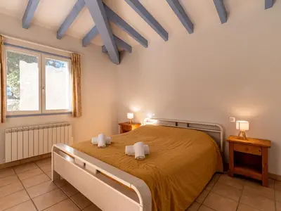a bedroom with a large bed with two towels at Villa Corba Bala by Interhome in Porto-Vecchio