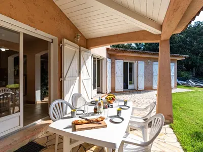 a white table and chairs on a patio at Villa Corba Bala by Interhome in Porto-Vecchio
