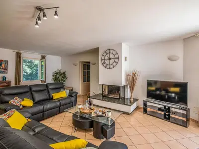 a living room with a couch and a tv at Villa Corba Bala by Interhome in Porto-Vecchio