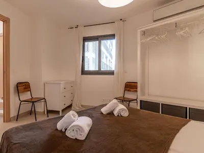 a bedroom with a bed with towels on it at Apartment Cita Di Sali 13 by Interhome in Porto-Vecchio
