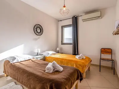 two beds in a room with towels on top of them at Apartment Cita Di Sali 13 by Interhome in Porto-Vecchio