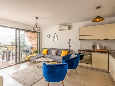 a living room with a couch and a table at Apartment Cita Di Sali 13 by Interhome in Porto-Vecchio