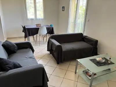 a living room with a couch and a table at Maison de charme à Ajaccio avec terrasse et jardin in Ajaccio
