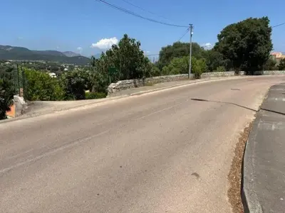 an empty road with a bridge in the distance at Maison de charme à Ajaccio avec terrasse et jardin in Ajaccio