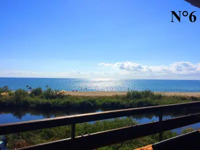 a view of the ocean from the balcony of a beach at Vista Mare Ghisonaccia in Ghisonaccia