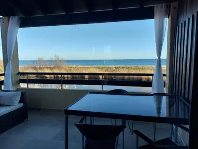 a room with a table and a view of the ocean at Vista Mare Ghisonaccia in Ghisonaccia