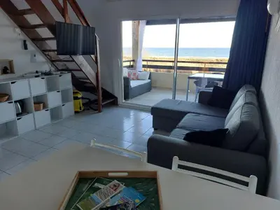 a living room with a couch and a view of the ocean at Vista Mare Ghisonaccia in Ghisonaccia
