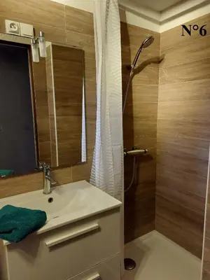 a bathroom with a sink and a shower with a mirror at Vista Mare Ghisonaccia in Ghisonaccia