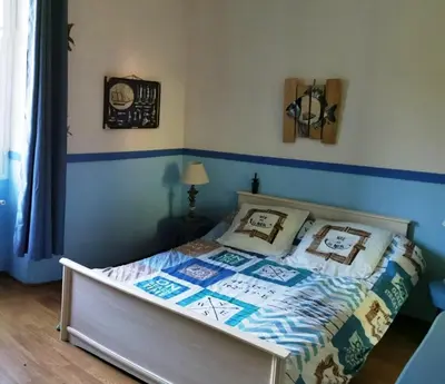 a bedroom with a bed with a blue and white comforter at Casa Maria in Vico