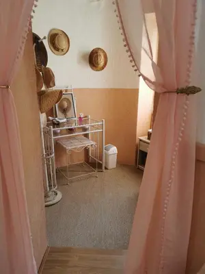 a room with a pink curtain and a table at Casa Maria in Vico