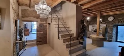 a hallway with a staircase and a chandelier at Domaine COLONNA SANTINI ,Chambre d hôtes Piscine, Spa in Porri