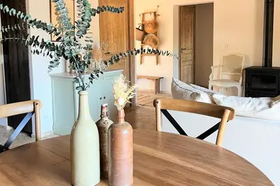 a table with three vases sitting on top of it at Casetta Soli Di Santa Lucia in Sainte-Lucie de Porto-Vecchio