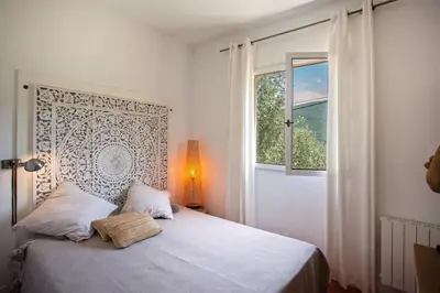 a living room with a television on a wooden table at Maison A Luna in Palasca
