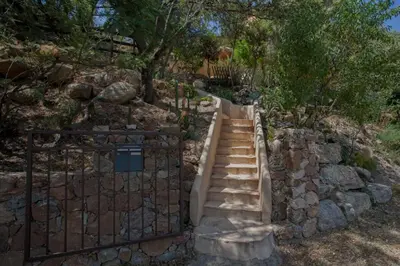 a stairway with a gate and a stone wall at Maison A Luna in Palasca
