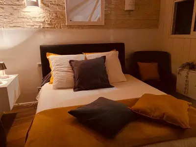 a large bed with two pillows on top of it at VILLA SANTONI in Porticcio