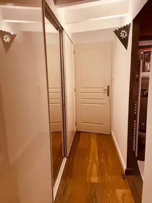 a hallway with a white door and a mirror at VILLA SANTONI in Porticcio