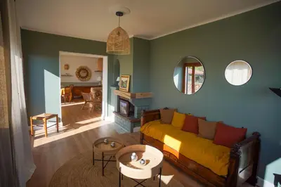 a living room with a yellow couch and a table at A CASA DI GEMMA in Appietto