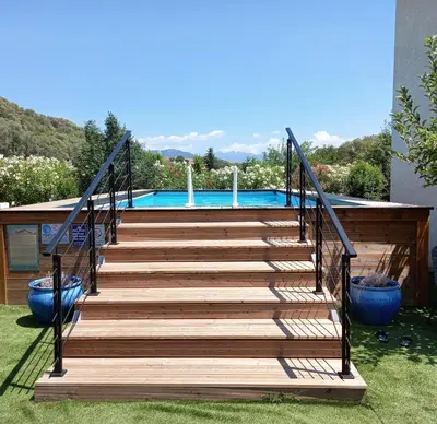 a wooden staircase leading up to a swimming pool at L'AMANDIER -LE FIGUIER-LES LAURIERS ROSES in Ajaccio