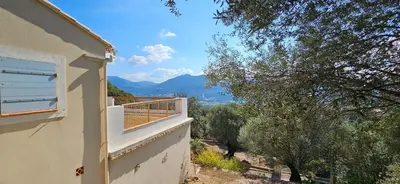 a balcony of a house with a view of the mountains at Super villa idyllique & antique avec vue mer imprenable in Olmeto