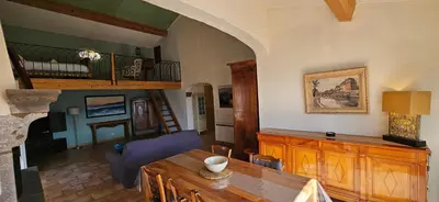 a living room with a table and a dining room at Super villa idyllique & antique avec vue mer imprenable in Olmeto