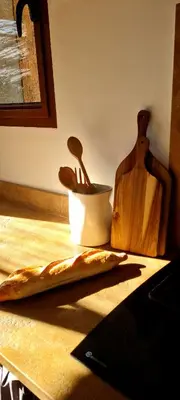 a table with a bowl and wooden utensils on it at Gianni Location Palombaggia in Porto-Vecchio