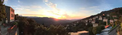 a view of a city with the sunset in the background at Campu Latinu in Lama