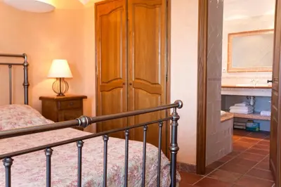 a bedroom with a bed and a wooden closet at Campu Latinu in Lama