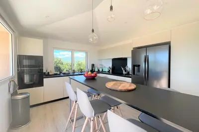 a kitchen with a black counter and white cabinets at Villa Surella Di Fautea in Conca