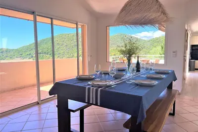 a dining table with a blue table cloth and wine glasses at Villa Surella Di Fautea in Conca