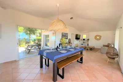 a dining room with a blue table and a living room at Villa Surella Di Fautea in Conca