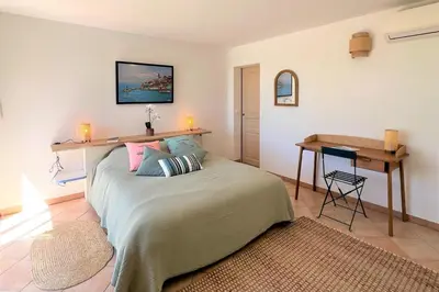 a bedroom with a bed with a table and a desk at Villa Surella Di Fautea in Conca