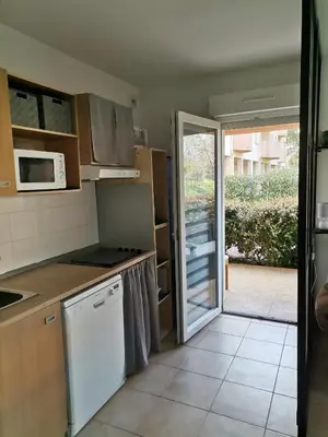 a kitchen with a door leading to a patio at Esperanza in Moriani Plage